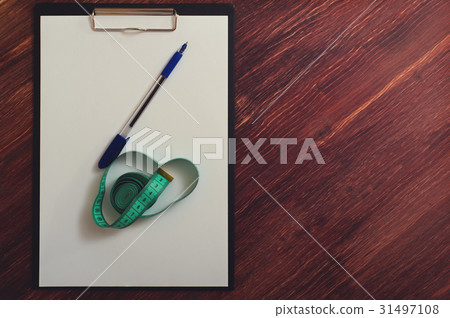 Blank clipboard, pen and measuring tape on table 31497108