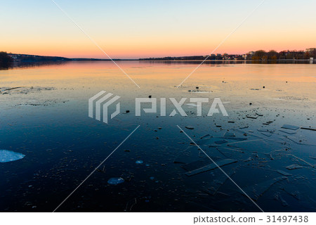 iced lake at sunset 31497438