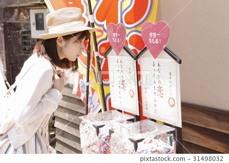 A young woman worried about Omikuji A young woman worried about Omikuji 31498032