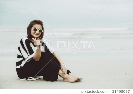portrait asian single hipster indy on the beach 31498057
