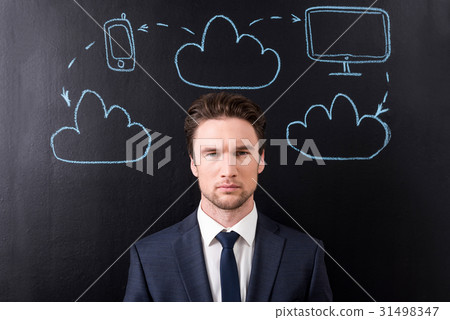 Pleasant businessman is expressing confidence Pleasant businessman is expressing confidence 31498347