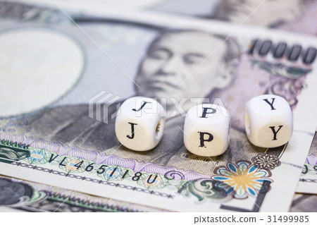 wooden cube with text "J P Y" on banknote YEN wooden cube with text "J P Y" on banknote YEN 31499985