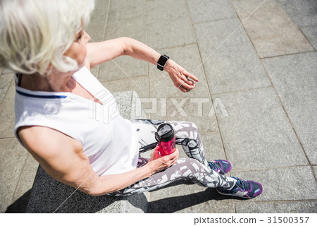 Elderly lady relaxing after sport activities Elderly lady relaxing after sport activities 31500357