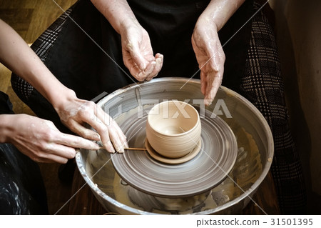 Master class on modeling of clay on potter's wheel 31501395