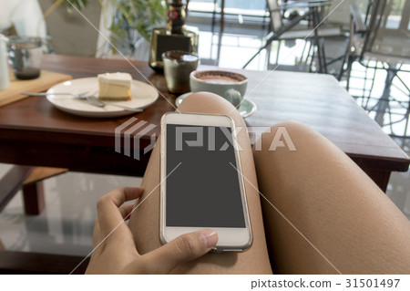 woman play smartphone in coffee shop. woman play smartphone in coffee shop. 31501497