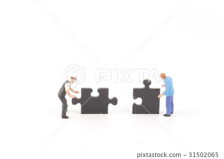 figure holding up jigsaw puzzle pieces 31502065