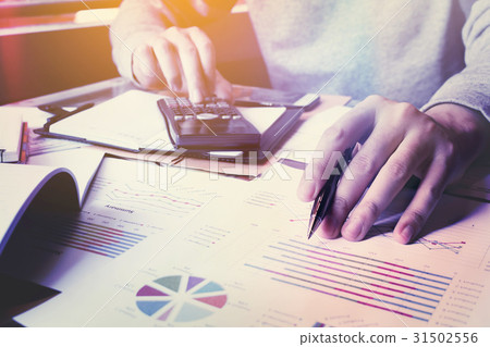 Businessman thinking about cost and doing finance Businessman thinking about cost and doing finance 31502556