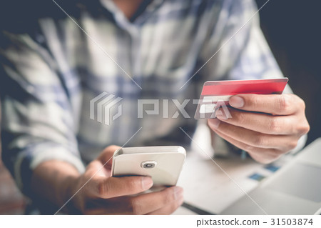Online payment,Man's hands holding a credit card Online payment,Man's hands holding a credit card 31503874