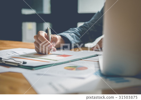 Businessman analyzing report on chart Businessman analyzing report on chart 31503875