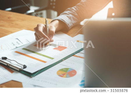 Businessman analyzing report on chart  31503876