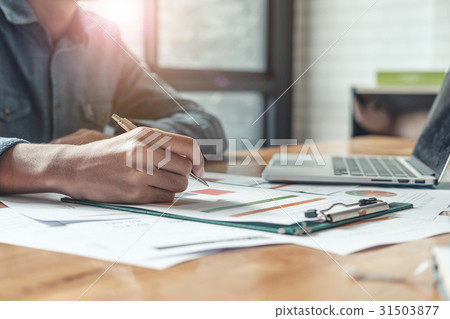 Businessman analyzing report on chart Businessman analyzing report on chart 31503877