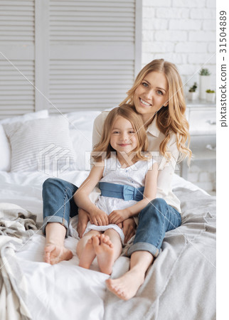 Sweet pleasant single-parent family bonding on bed Sweet pleasant single-parent family bonding on bed 31504889
