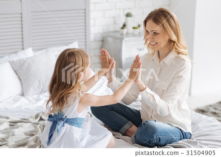 Pretty young mother plying pat-a-cake game with 31504905