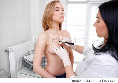 Young woman getting breast examination at the 31505538