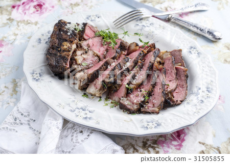 Barbecue Rib-Eye Steak sliced on Plate 31505855