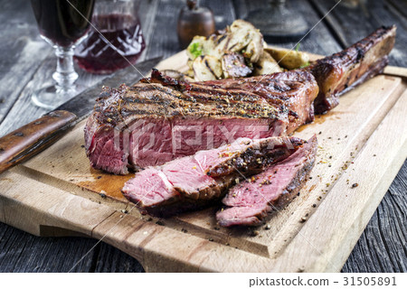 Barbecue Tomahawk Steak on Cutting Board 31505891