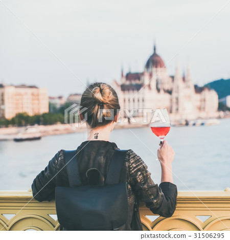 Woman standing with glass of wine in Budapest Woman standing with glass of wine in Budapest 31506295