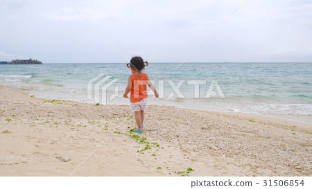 A girl walking along the coast 31506854