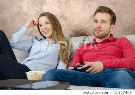 Couple enjoys free time and playing video games. 31507466