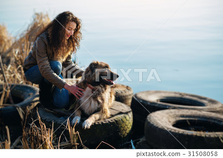 Woman playing with Caucasian shepherd dog, autumn 31508058