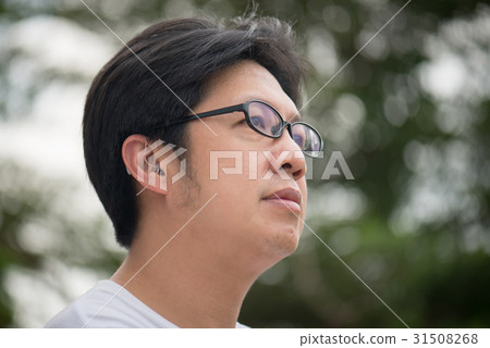 man with hearing aid behind the ear 31508268