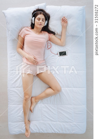 Joyful positive woman listening to music Joyful positive woman listening to music 31508272