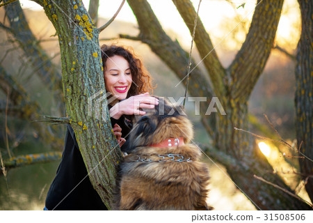 Woman playing with Caucasian shepherd dog, autumn 31508506