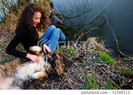 Woman playing with Caucasian shepherd dog, autumn 31508513