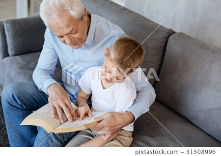 Original awesome man teaching his grandson reading Original awesome man teaching his grandson reading 31508996