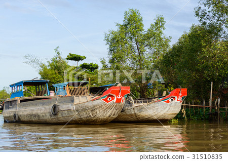 Wooden cargo boat on the Mekong River Delta Wooden cargo boat on the Mekong River Delta 31510835