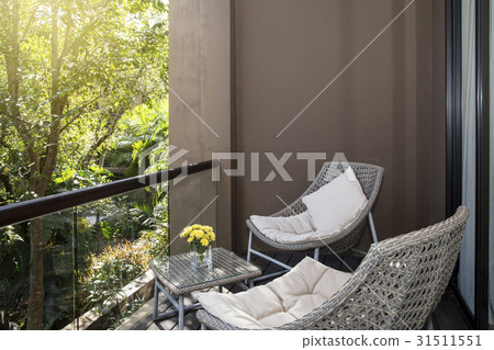 Wicker chair with view at terrace 31511551
