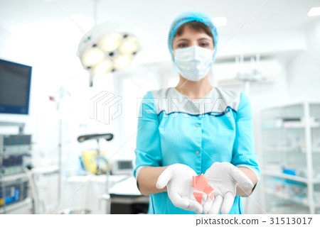 Female doctor holding breast cancer awareness pink Female doctor holding breast cancer awareness pink 31513017