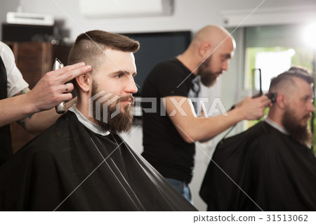 Professional barber doing a haircut 31513062