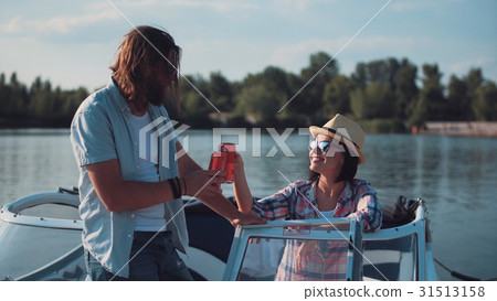 Young couple toasting each other in a motorboat 31513158
