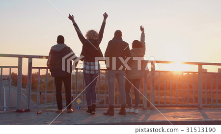 Family of four stands at barrier to observe nature Family of four stands at barrier to observe nature 31513190