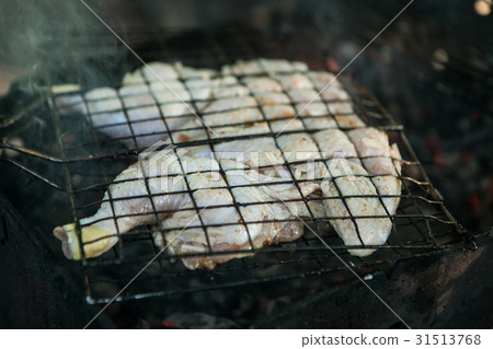 Fried chicken on the barbecue grill cooked on the 31513768