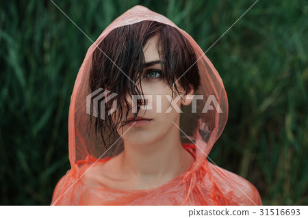 The portrait of girl in red raincoat The portrait of girl in red raincoat 31516693