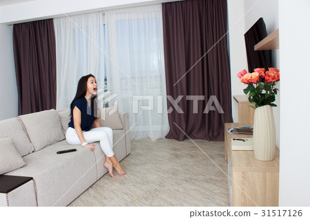 Woman watching horror film at night Woman watching horror film at night 31517126