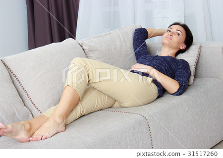 beautiful young woman lying on the couch 31517260