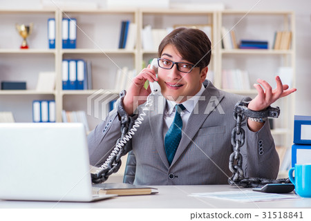 Businessman tied with chains to his work Businessman tied with chains to his work 31518841