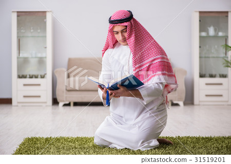 Arab man praying at home Arab man praying at home 31519201