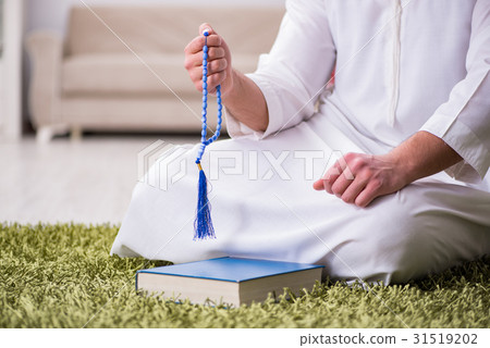 Arab man praying at home Arab man praying at home 31519202