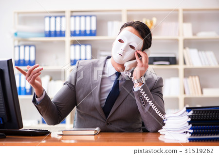 Businessman with mask in office hypocrisy concept 31519262