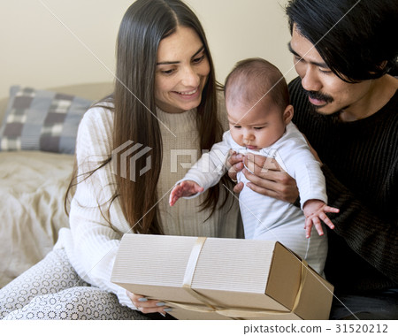 Father and mother are taking care of their child. 31520212