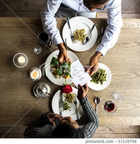 Man giving a rose and propose for the lady at dinner 31520708