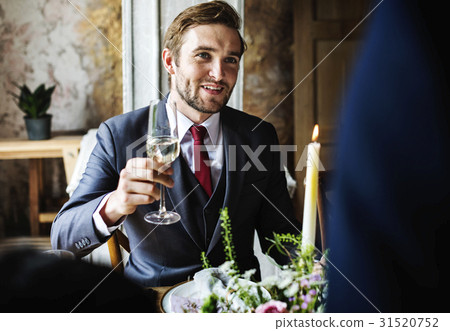 Bride and Groom Clinging Wineglasses with Friends on Wedding Reception Bride and Groom Clinging Wineglasses with Friends on Wedding Reception 31520752