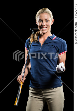 Portrait of golf player holding a golf club and golf ball Portrait of golf player holding a golf club and golf ball 31522387