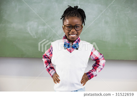 Portrait of happy schoolgirl standing with hand on hip Portrait of happy schoolgirl standing with hand on hip 31522659