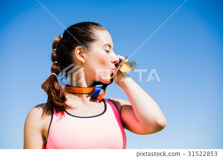 Female athlete kissing her gold medals 31522853