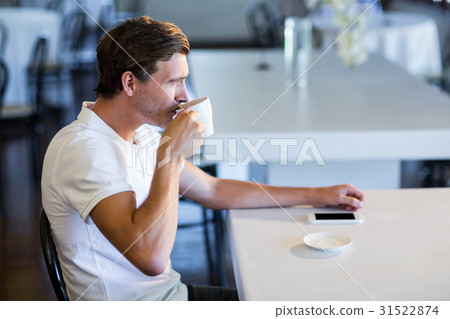 Man drinking cup of coffee 31522874